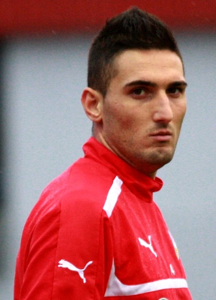 Federico Macheda in a red training top looking over his shoulder