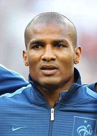 Florent Malouda in a France training top, close-up portrait.