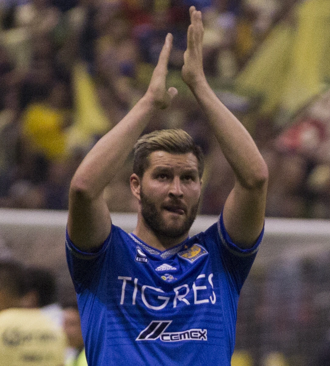 André-Pierre Gignac in a blue Tigres jersey applauding on the pitch